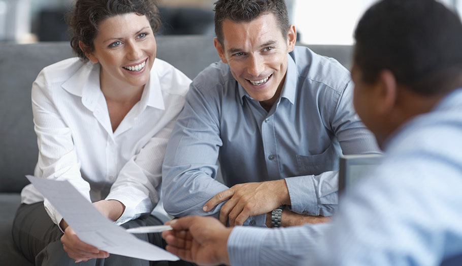 Couple getting advice from their stock broker.